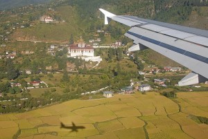 plane over buthan with village below