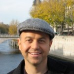 alan watt in hat in front of lake