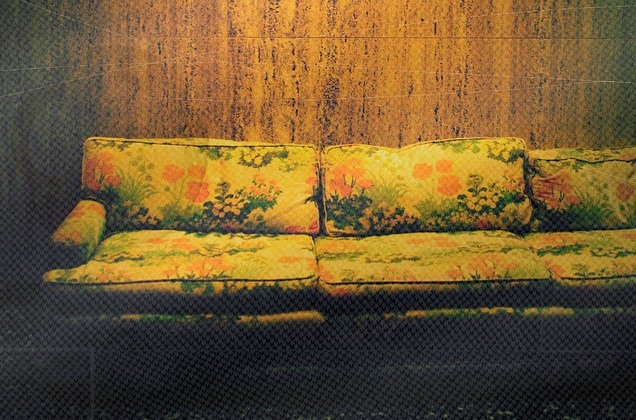 Old couch with green and orange flowers