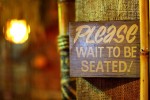 please wait to be seated sign at diner