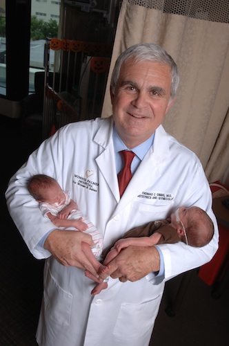 thomas gibbs in doctor coat with his grandtwins