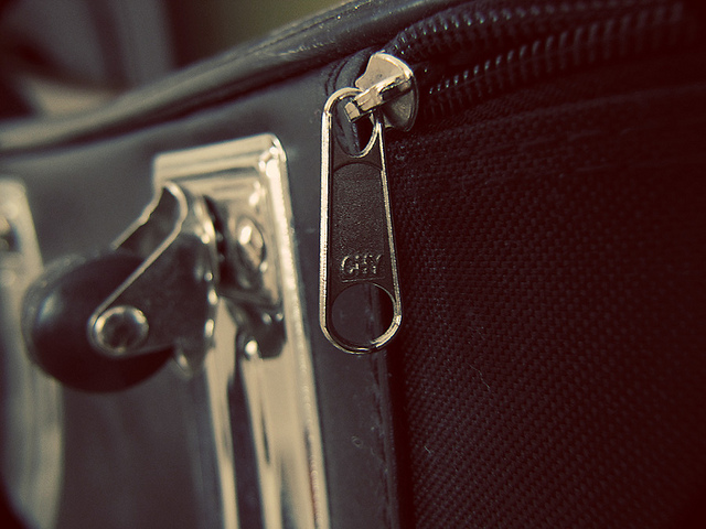 Close up shot of suitcase on zipper and wheel