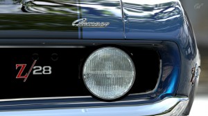 Blue camaro close up of headlight and hood
