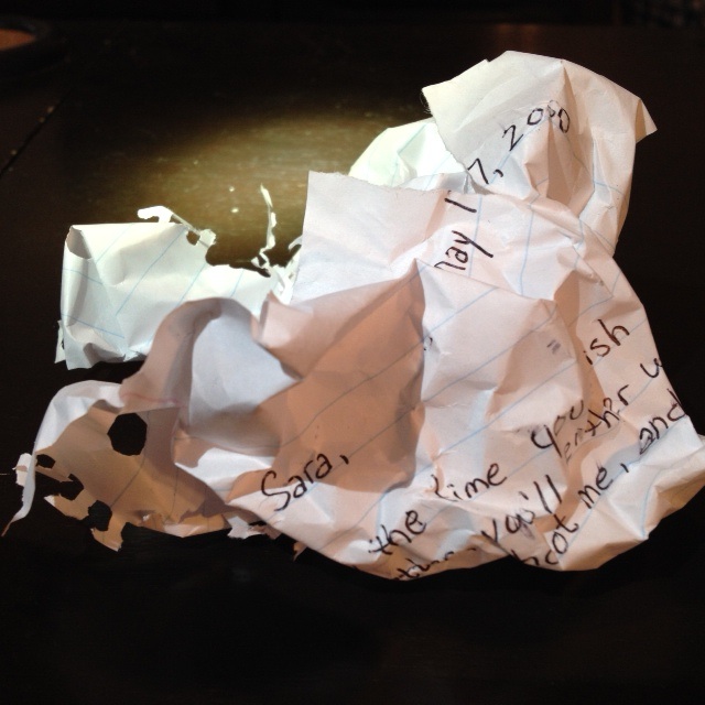 Crumpled up paper of letter with sarah