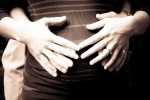 pregnant belly close up with hands on it