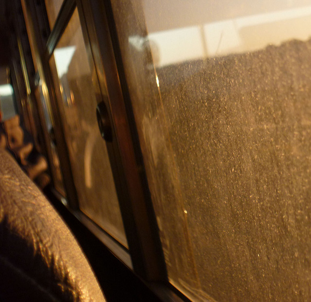 Close up of school bus window looking out dirty