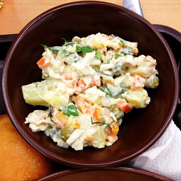 Bowl of salat olivier veggies mixed with mayo