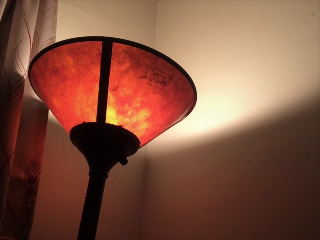 lamp on shining on ceiling leaving a soft glow