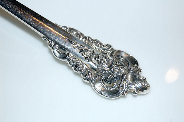 Ornate handle of a silver spoon