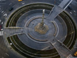 aerial view of Columbus Circle, a traffic circle with grass and monument in middle