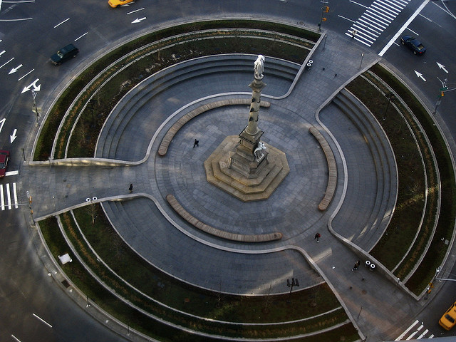aerial view of Columbus Circle, a traffic circle with grass and monument in middle