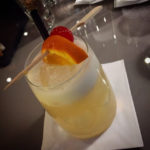 whiskey and oj with orange slice and cherry