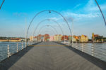 queen emma bridge willemstad curacao floating wooden bridge with arches and colorful city buildings behind photo by dronepicr