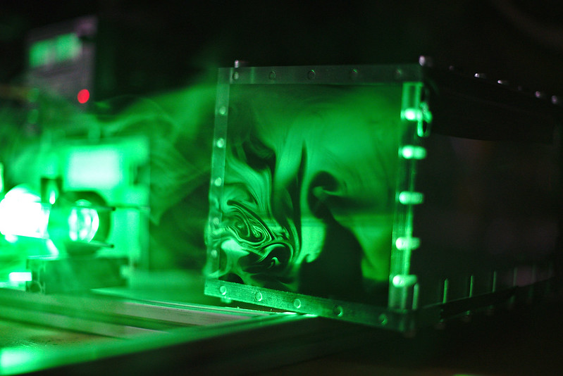 abstract photo of concert stage with smoke swirling in green light