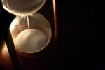 hour glass with sand falling to bottom glass bulb