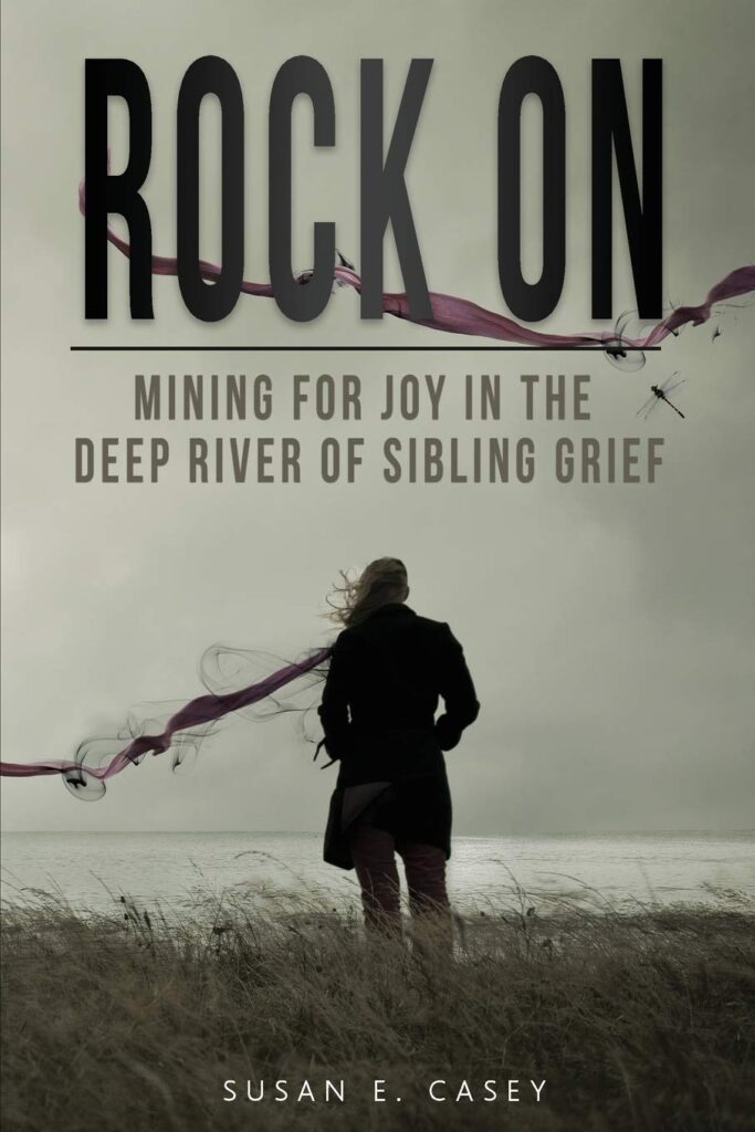 Cover of rock on sibling grief woman in field with back truned looking at water