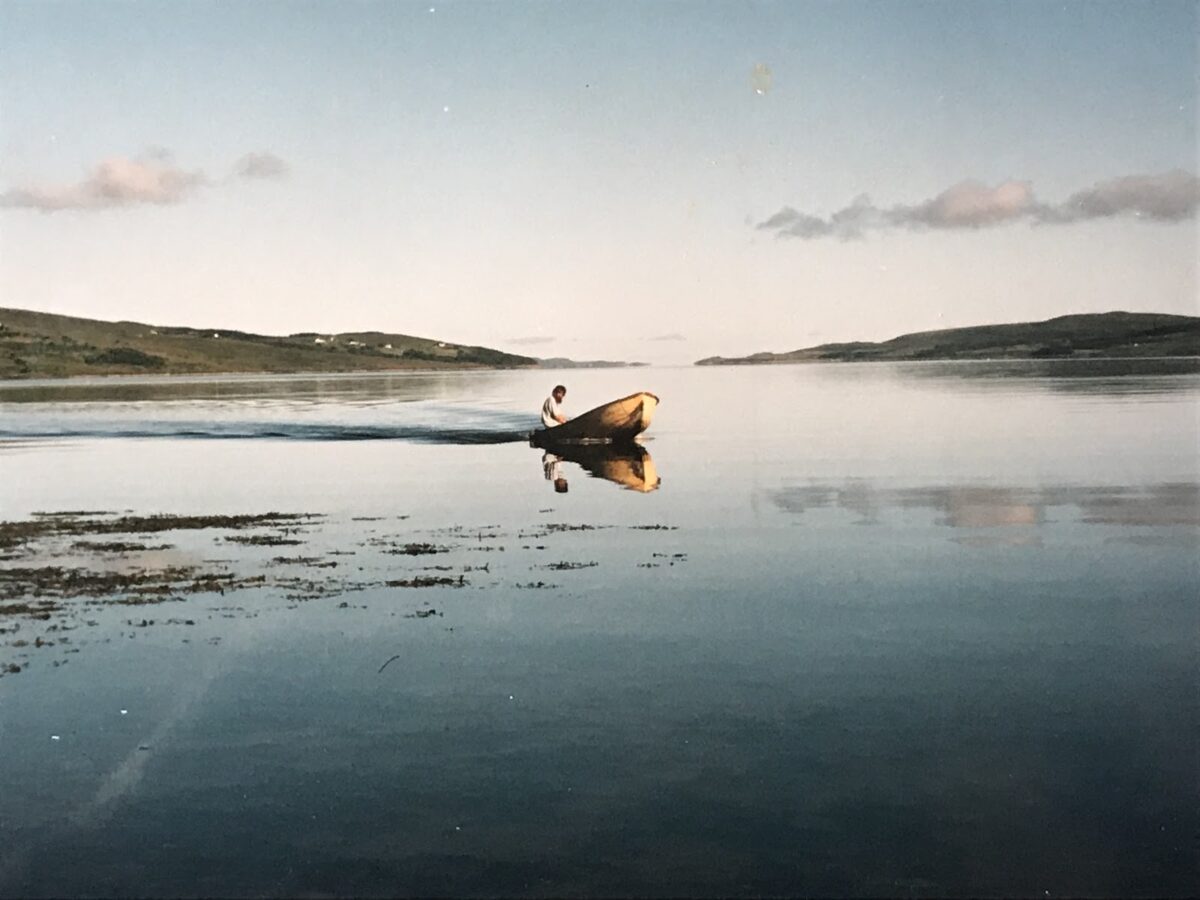 Author's father in dinghy, coming to shore