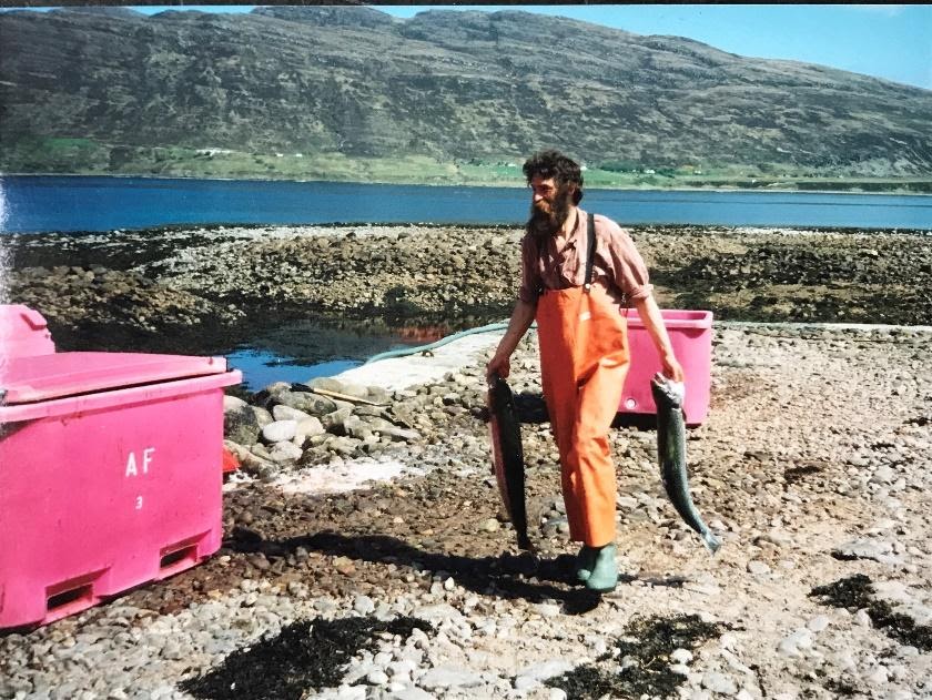 Author's father, with beard, carrying fish to a crate