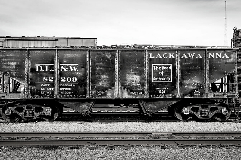 b+w photo of a full coal car from Lackawanna Railroad, " The Road of Anthracite" written on wall