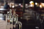 empty beer mug with bar faded in back