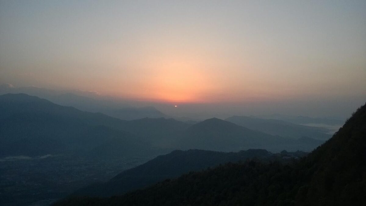 sunset at horizon over mountains
