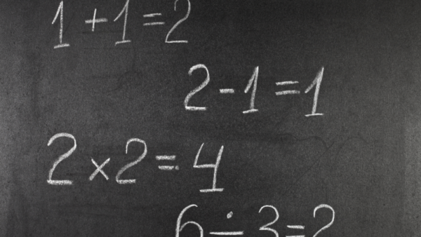 simple math equations in white chalk on a blackboard