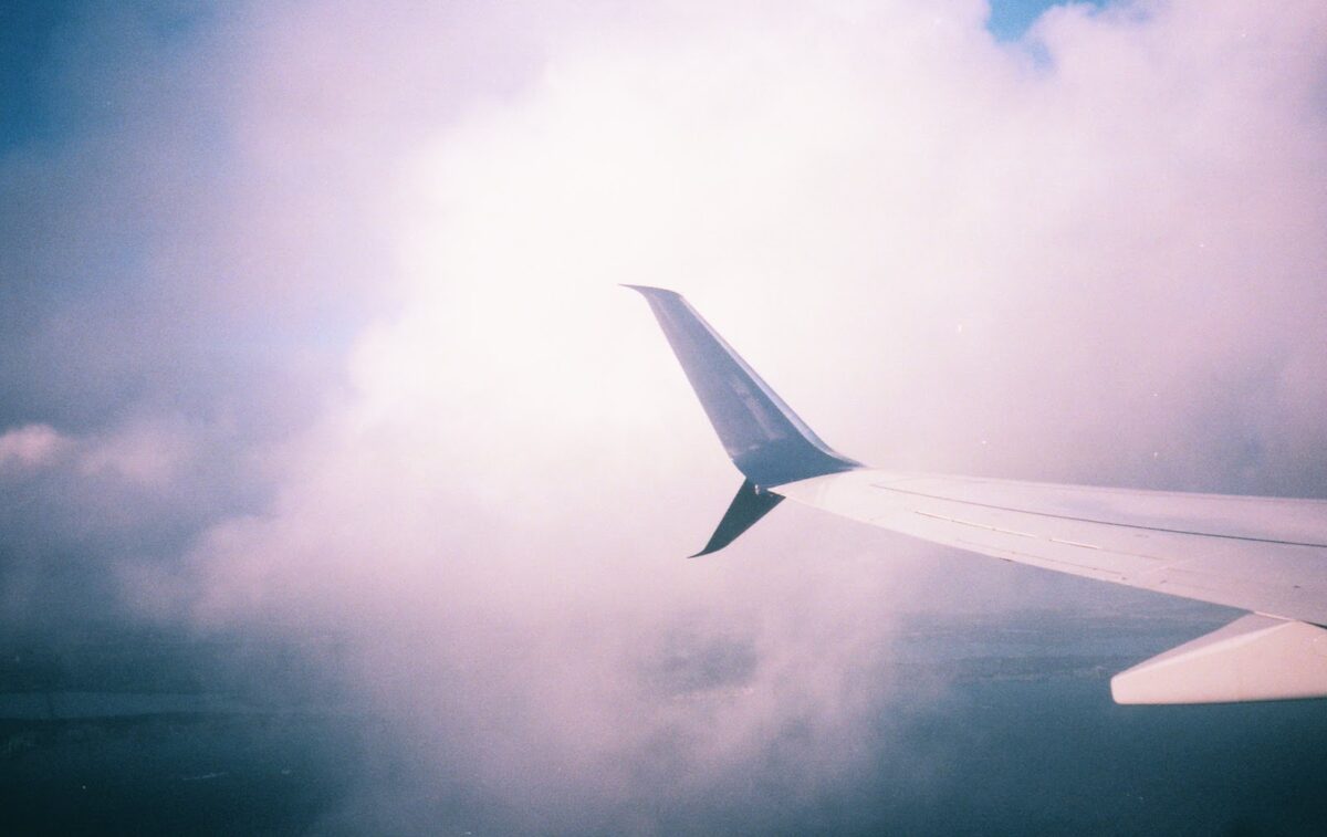 airplane wing in pink clouds