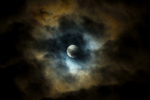 full moon, but partially hidden behind dark clouds