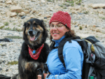 author sarah boon outside with backpack, with her dog