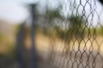 close up of wire fence of the standard playground variety