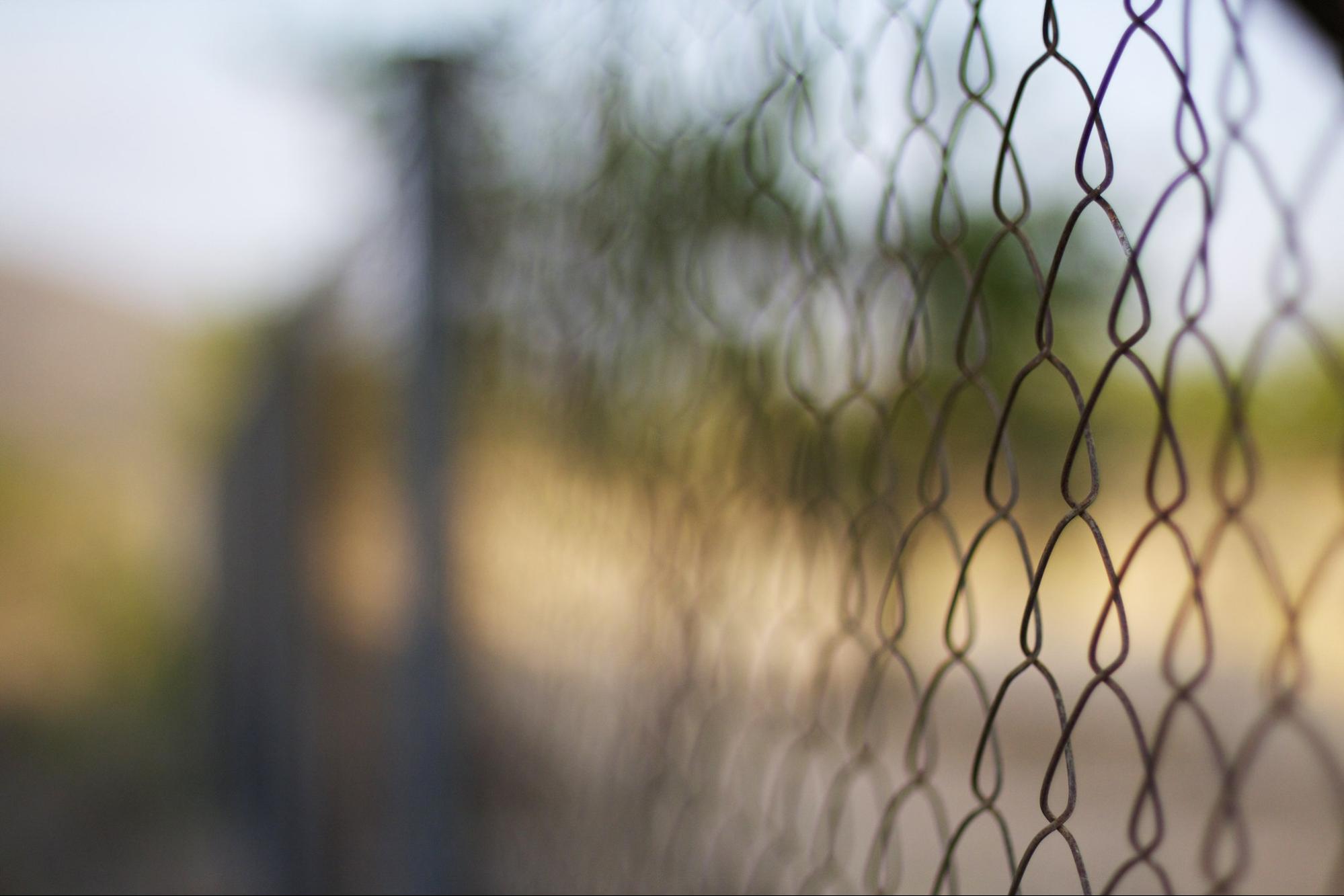 close up of wire fence of the standard playground variety