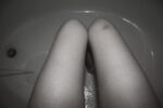 woman's legs, seated in tub