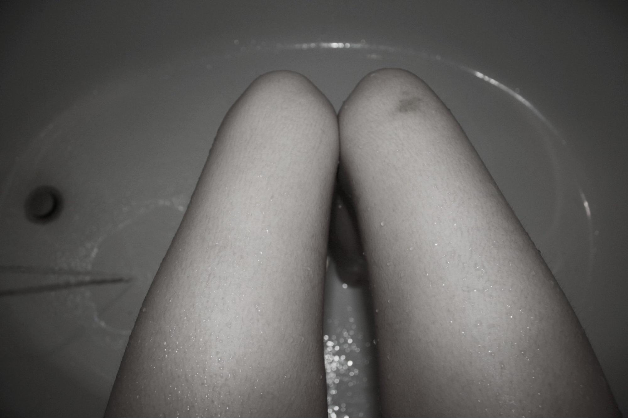 woman's legs, seated in tub