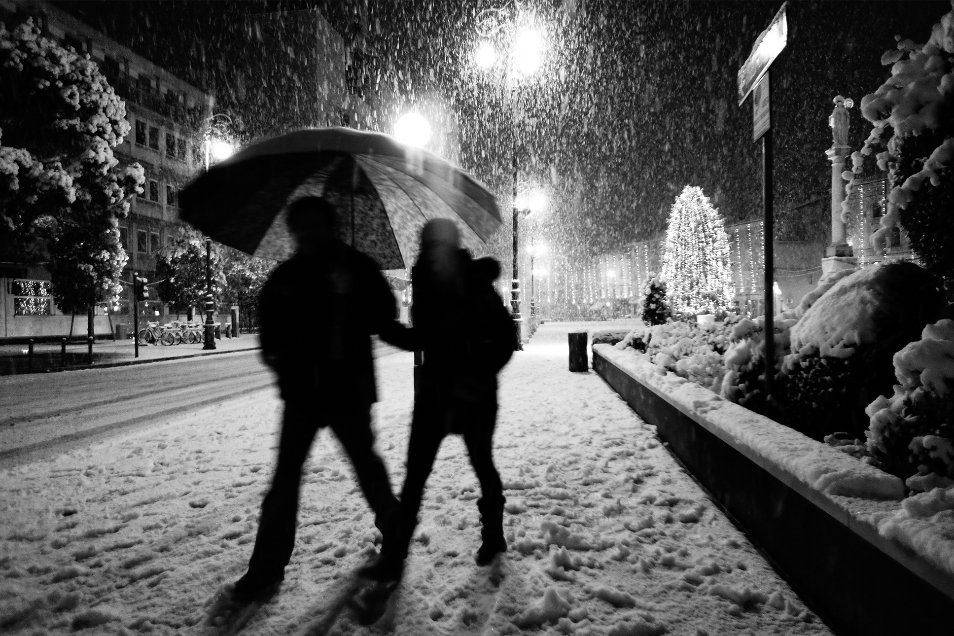 couple walking in snowy city