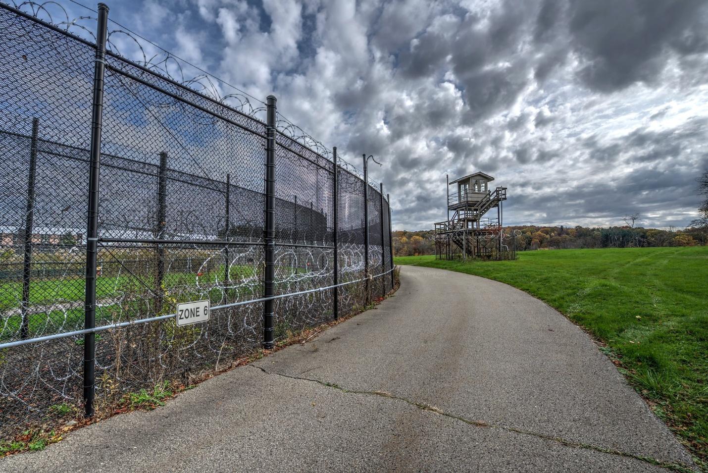 exterior of prison gate on cloudy day