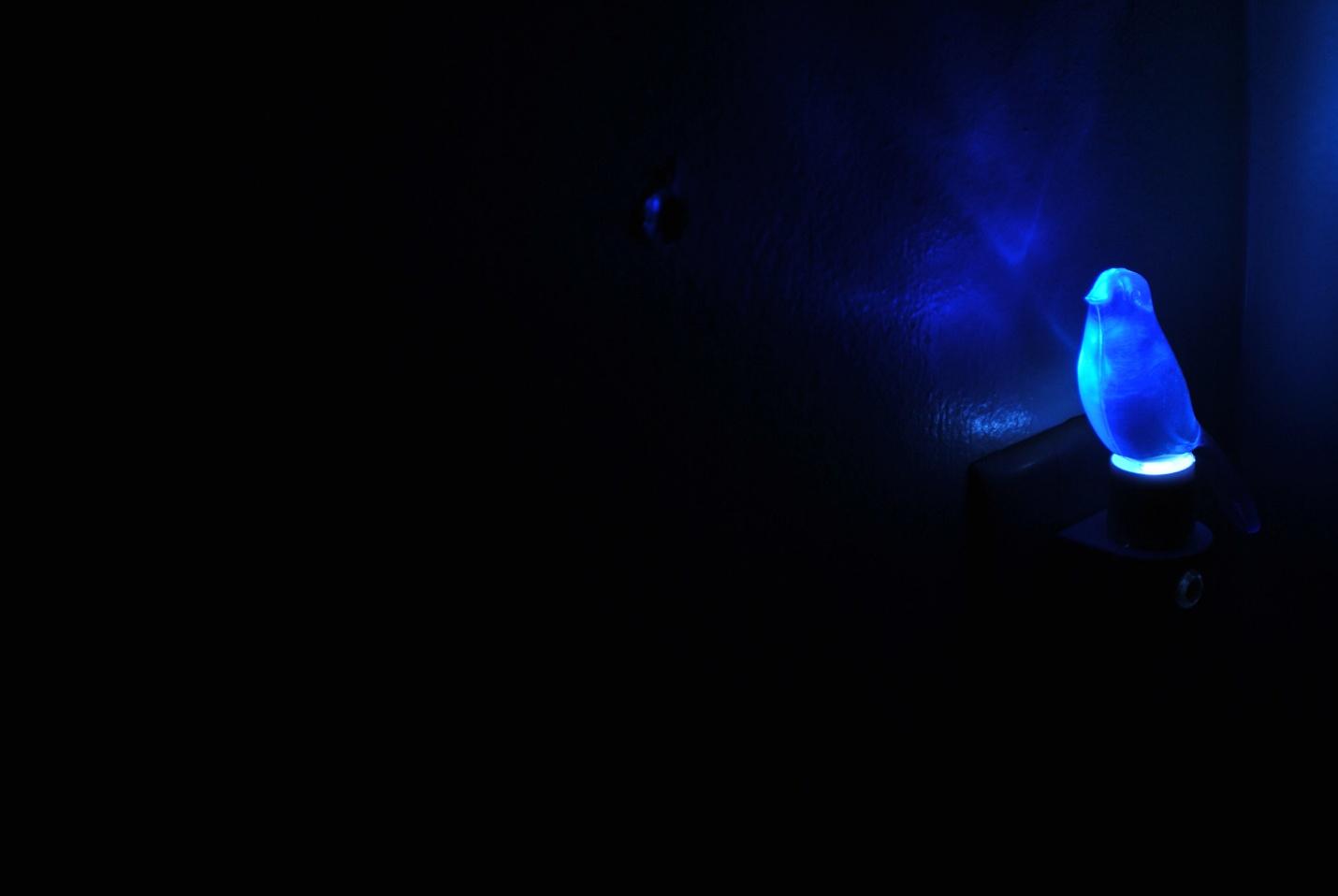 dark panel with a bright blue light lit up on the right side