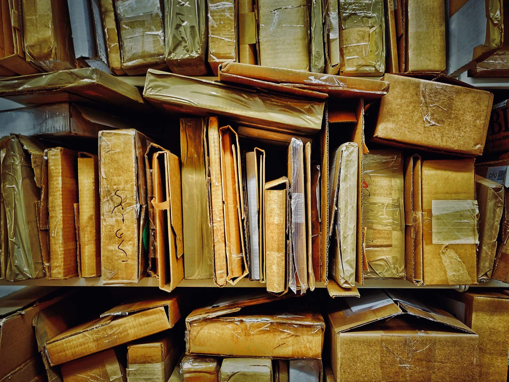 A stack of cardboard boxes on shelves