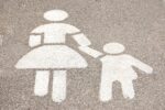 parking lot stencil of woman walking with child