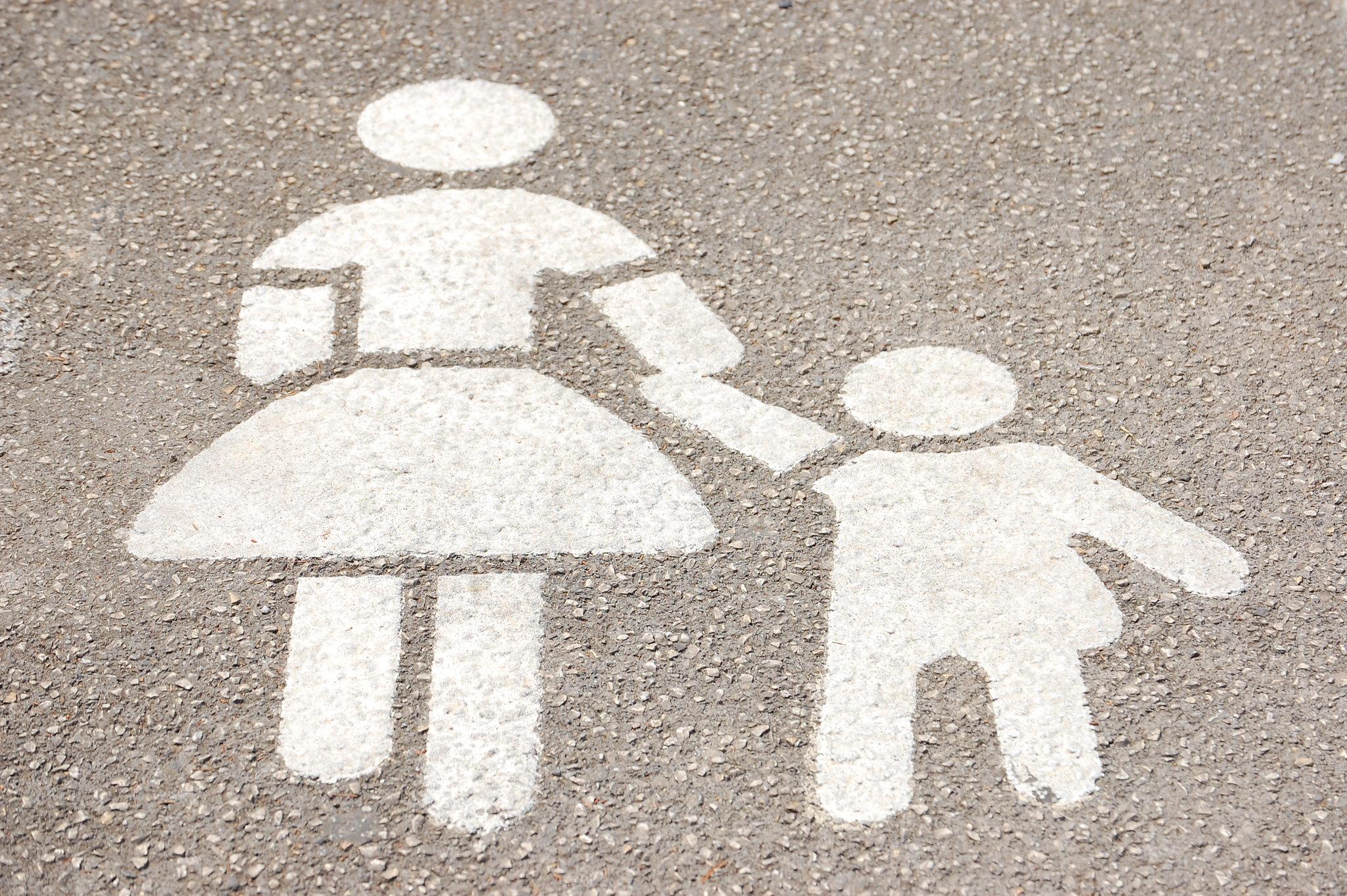 parking lot stencil of woman walking with child